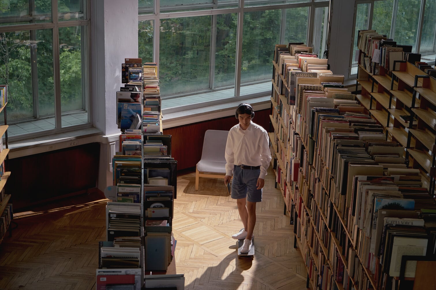 A Student Riding a Skateboard in a Library