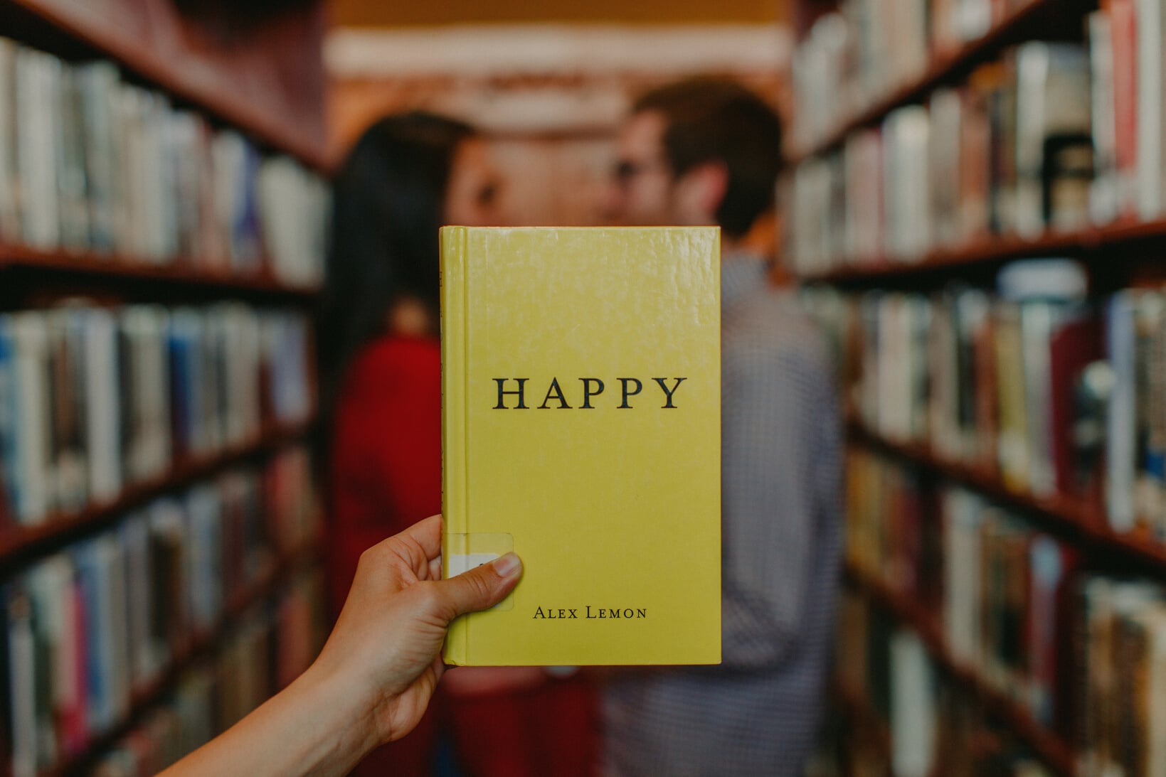 Happy Book against a Couple in the Library